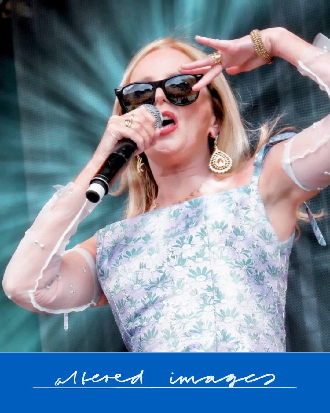 Female singer with sunglasses performing on stage at Heartland Festival.