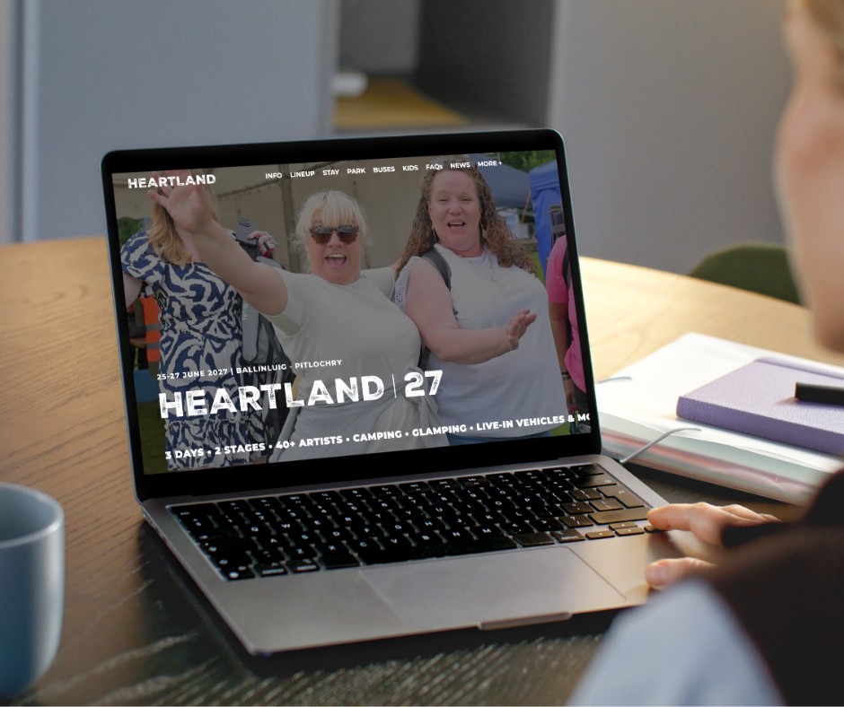 People enjoying Heartland Festival in Pitlochry, Perthshire on a laptop screen.