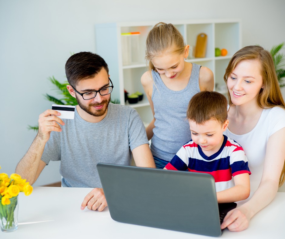 Payment Options (1) Family shopping online together with a laptop and credit card at home.